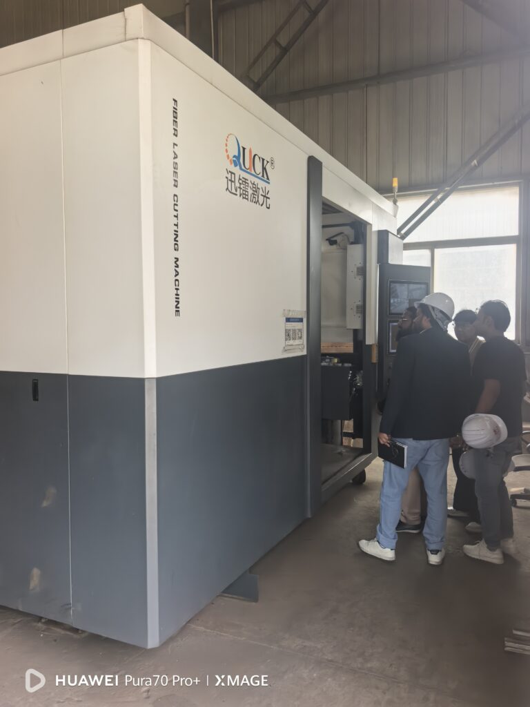 Customers reviewing laser cutting equipment